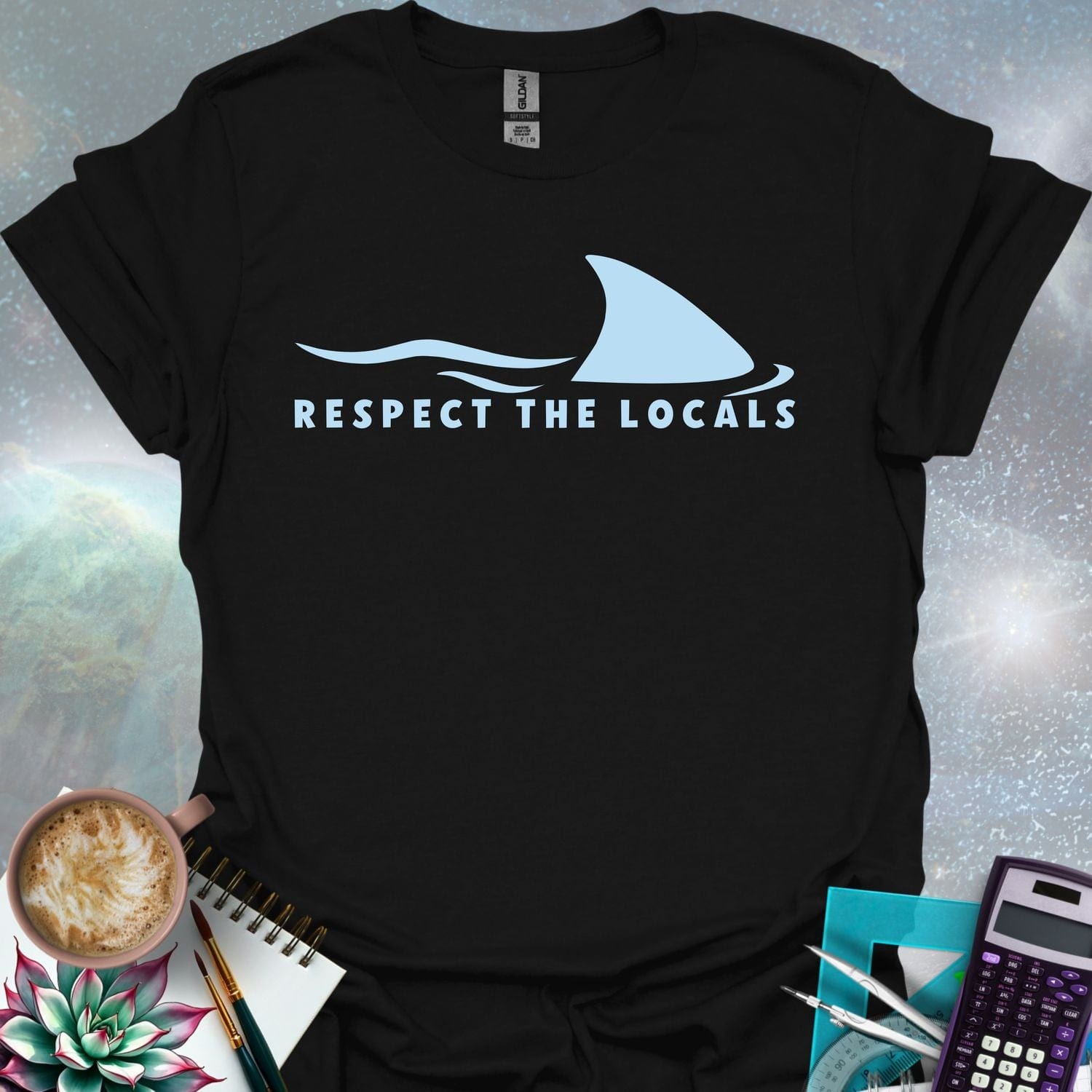 A blue shark fin rising above blue ocean waves, with the text 'RESPECT THE LOCALS' below.