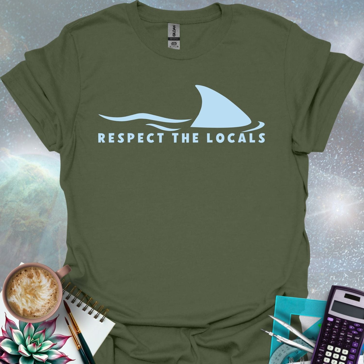 A blue shark fin rising above blue ocean waves, with the text 'RESPECT THE LOCALS' below.