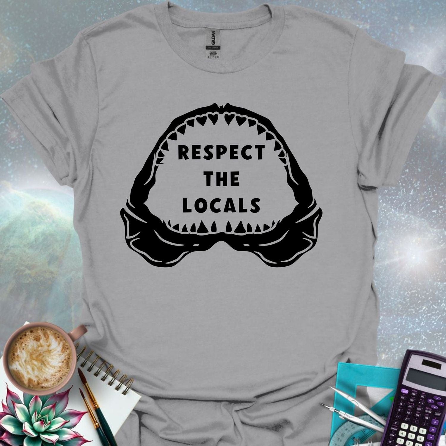 The silhouette of a menacing open shark jaw with sharp teeth, framing the text 'RESPECT THE LOCALS' in the center.