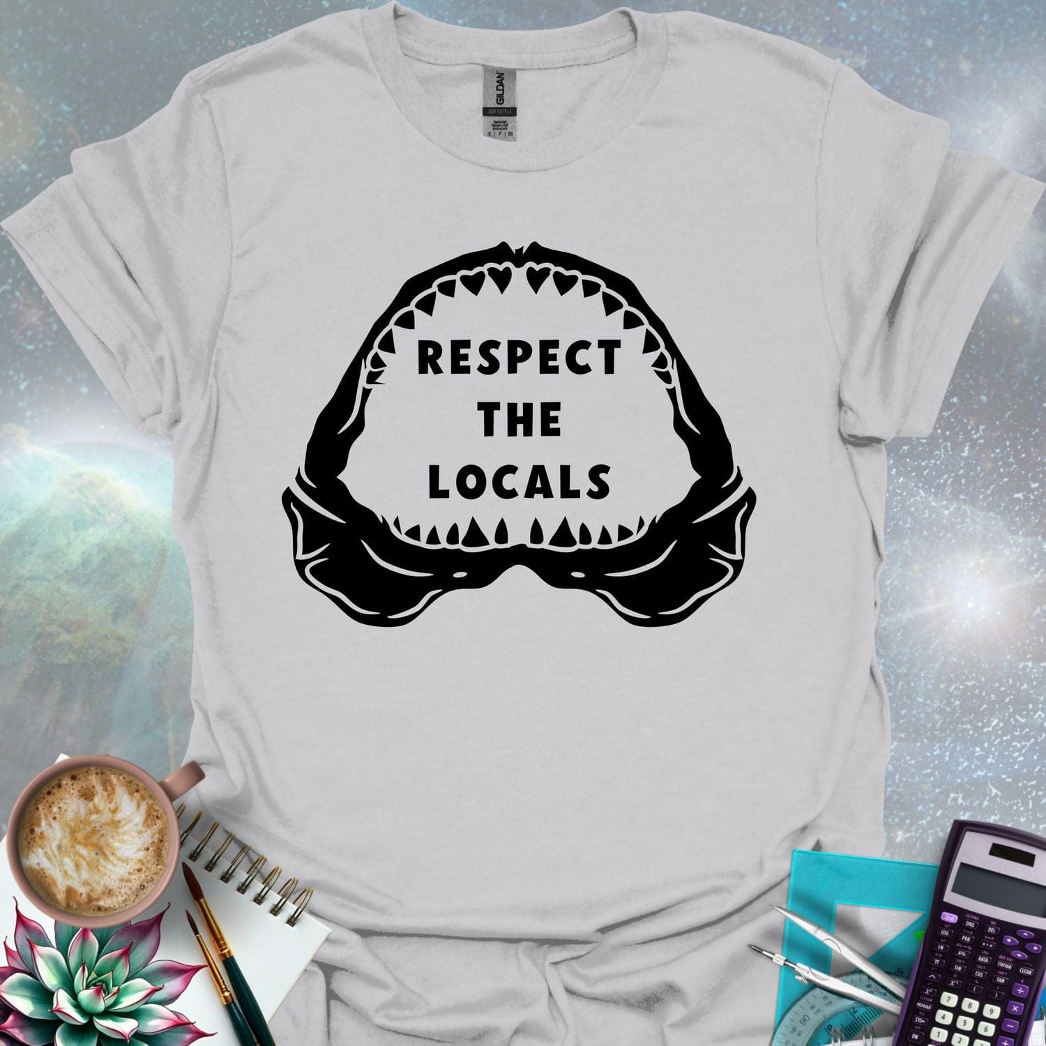The silhouette of a menacing open shark jaw with sharp teeth, framing the text 'RESPECT THE LOCALS' in the center.