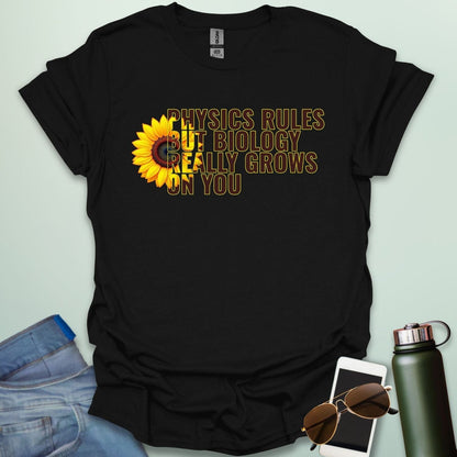 A funny biology t-shirt with a sunflower and the text 'Biology Really Grows On You,' a witty pun for biology teachers and plant lovers.