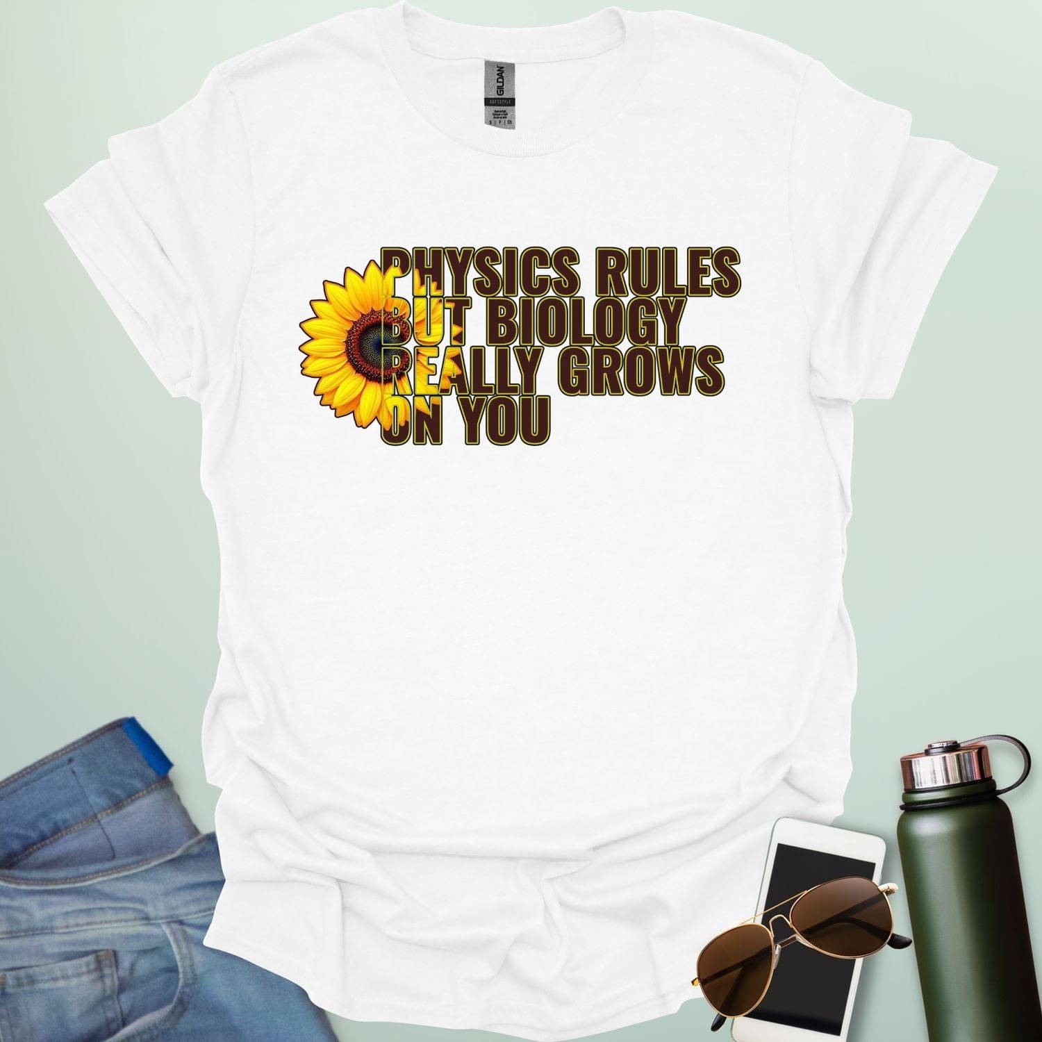 A funny biology t-shirt with a sunflower and the text 'Biology Really Grows On You,' a witty pun for biology teachers and plant lovers.