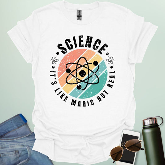 T-shirt with a clean design featuring an atom symbol and the quote 'Science - It's like magic but real'.