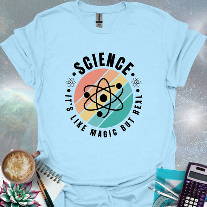 T-shirt with a clean design featuring an atom symbol and the quote 'Science - It's like magic but real'.