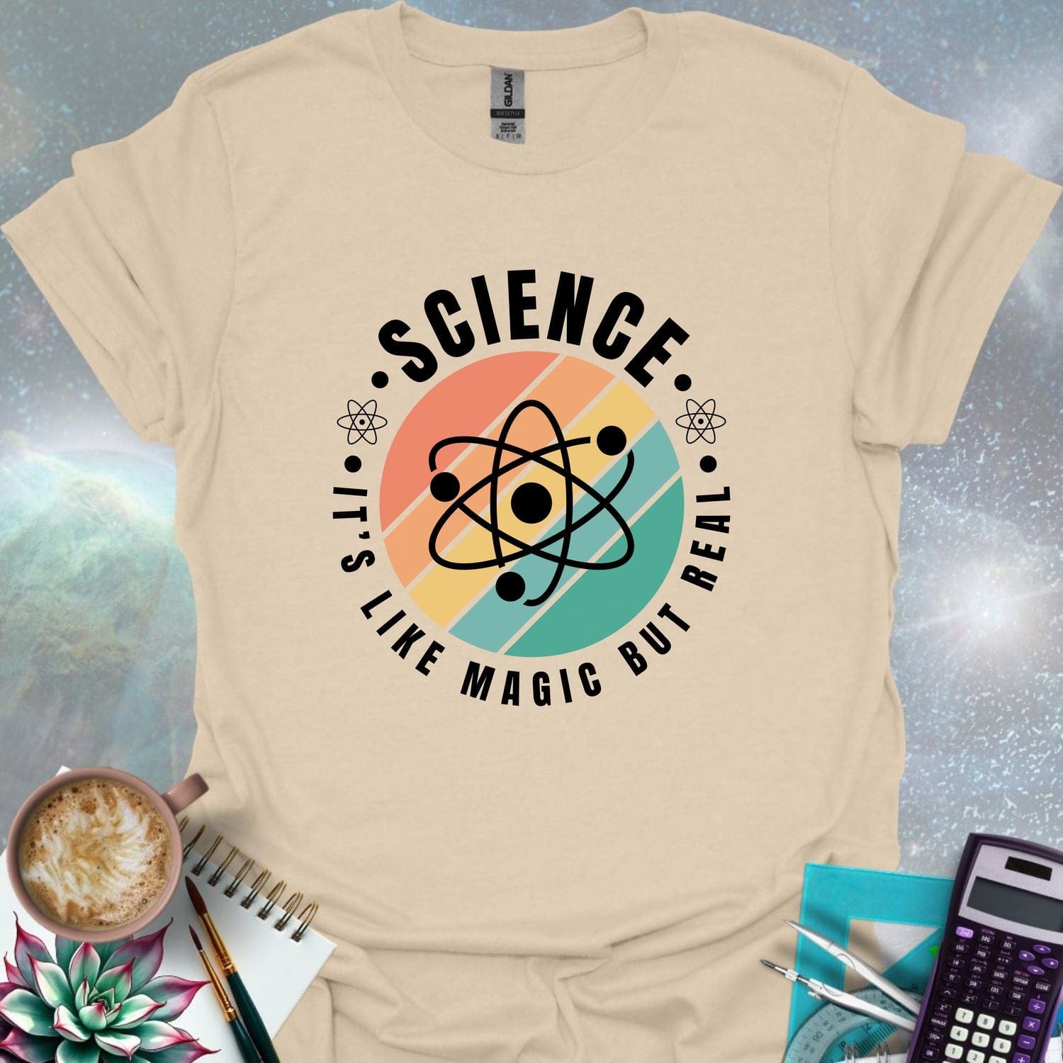 T-shirt with a clean design featuring an atom symbol and the quote 'Science - It's like magic but real'.