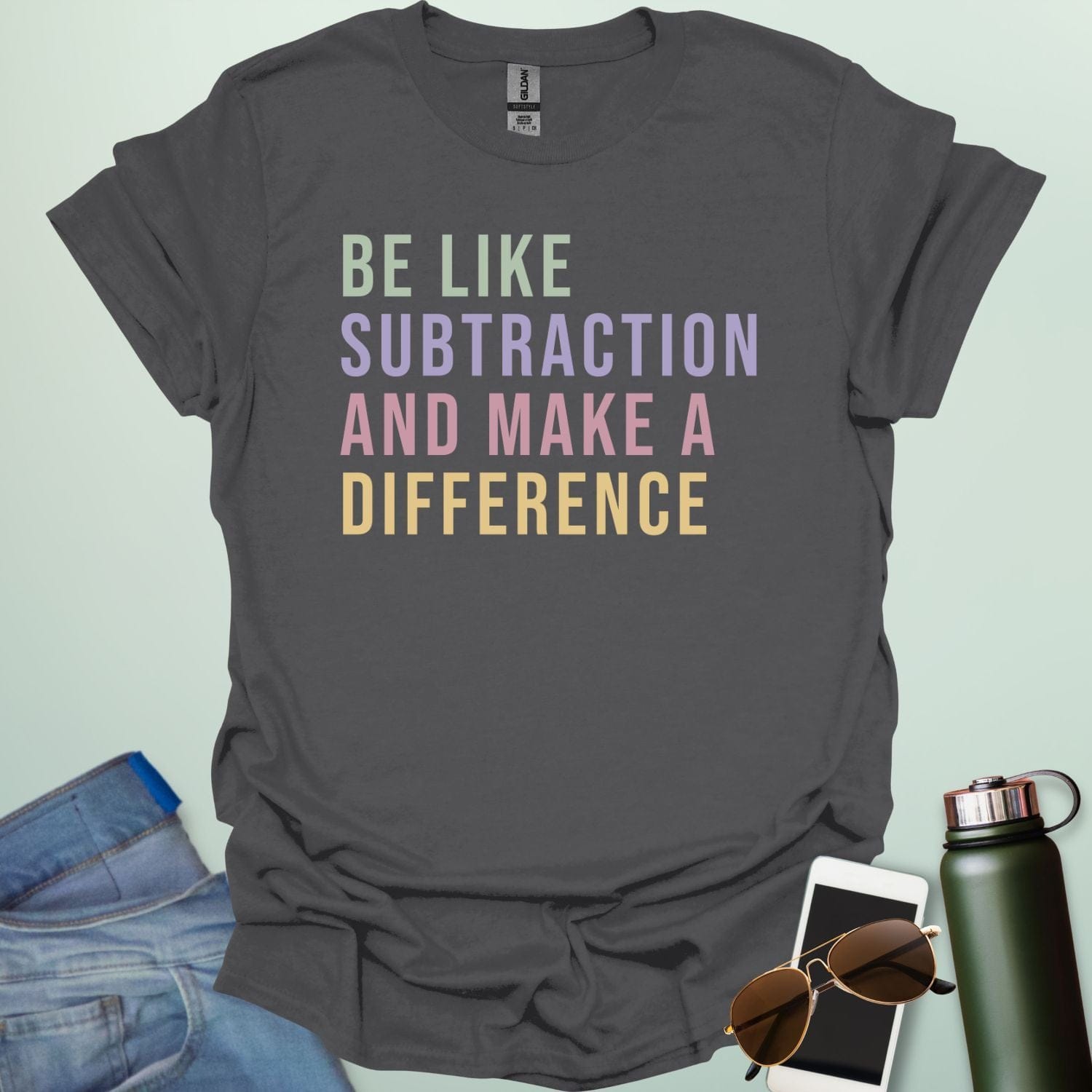 Colorful retro-style typography featuring the motivational math pun "BE LIKE SUBTRACTION AND MAKE A DIFFERENCE" in stacked green, purple, pink, and yellow text.
