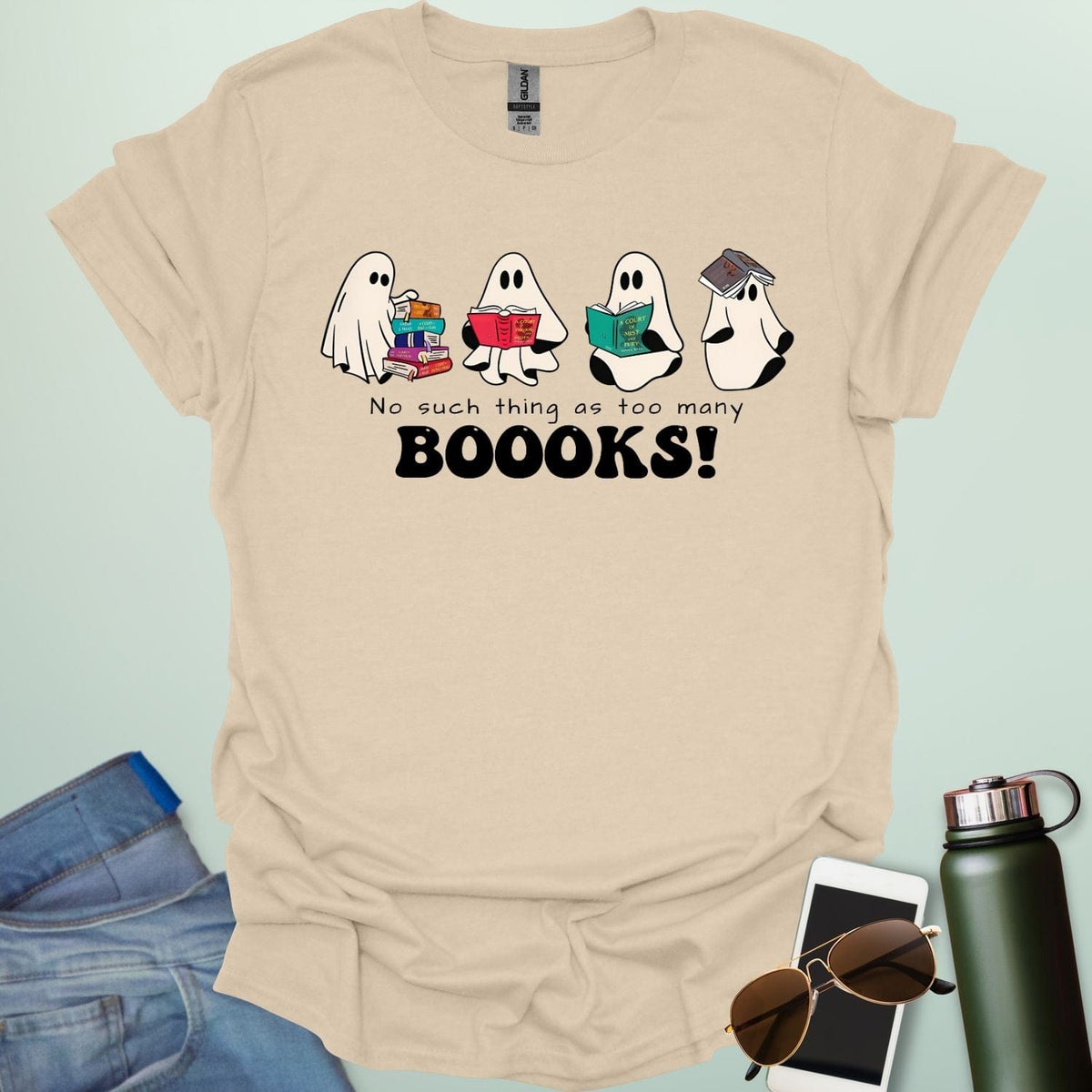 No Such Thing As Too Many Booooks t-shirt with ghostly lettering and book graphic — a spooky bookworm design for readers and teachers.