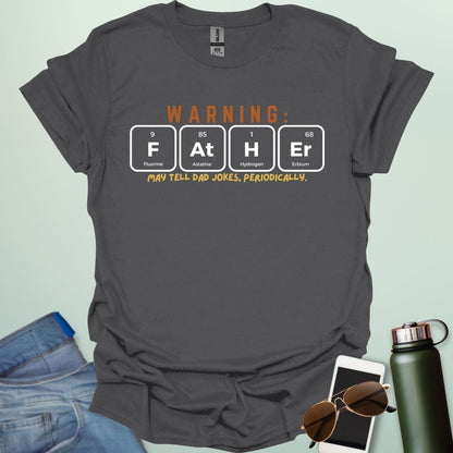 A funny periodic table t-shirt for fathers, using the elements Fluorine, Astatine, Hydrogen, and Erbium to spell 'FAtHEr'. The design says 'WARNING: FATHER MAY TELL DAD JOKES, PERIODICALLY.'