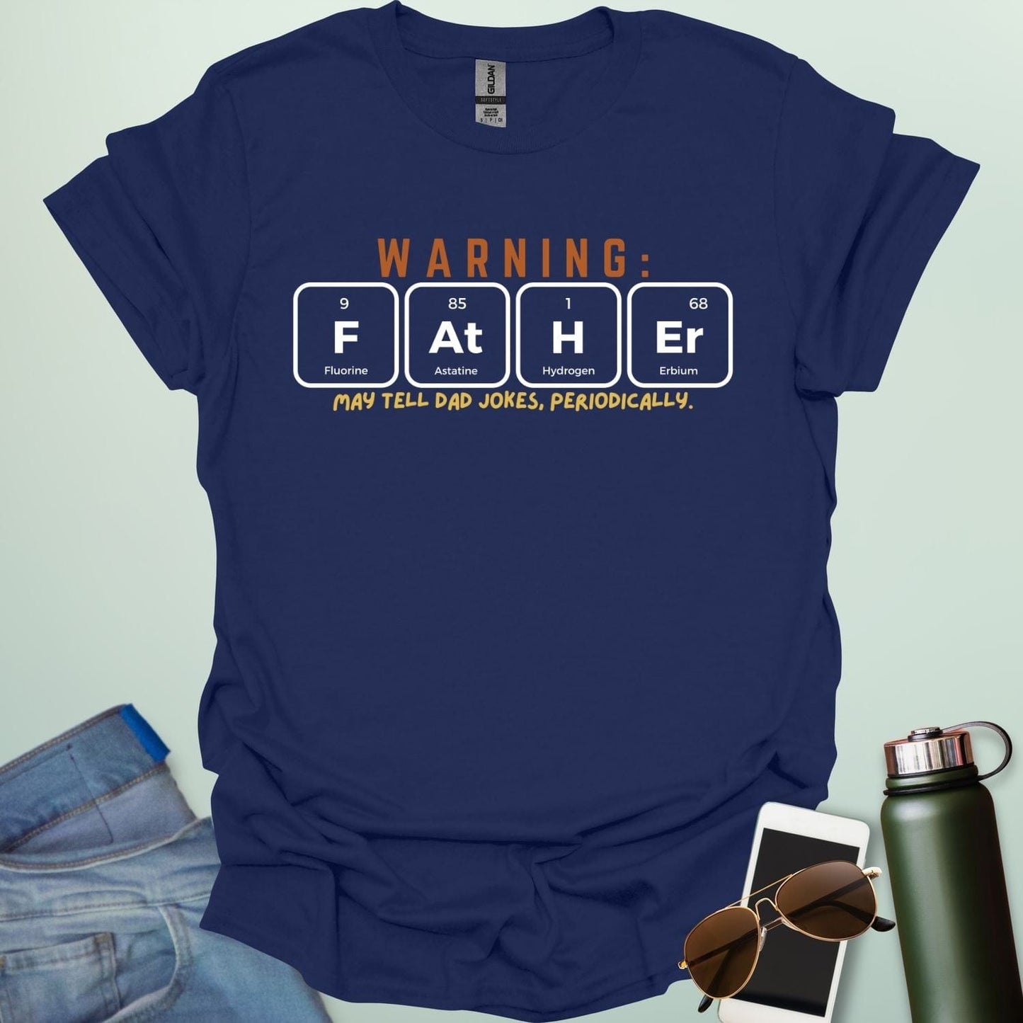 A funny periodic table t-shirt for fathers, using the elements Fluorine, Astatine, Hydrogen, and Erbium to spell 'FAtHEr'. The design says 'WARNING: FATHER MAY TELL DAD JOKES, PERIODICALLY.'