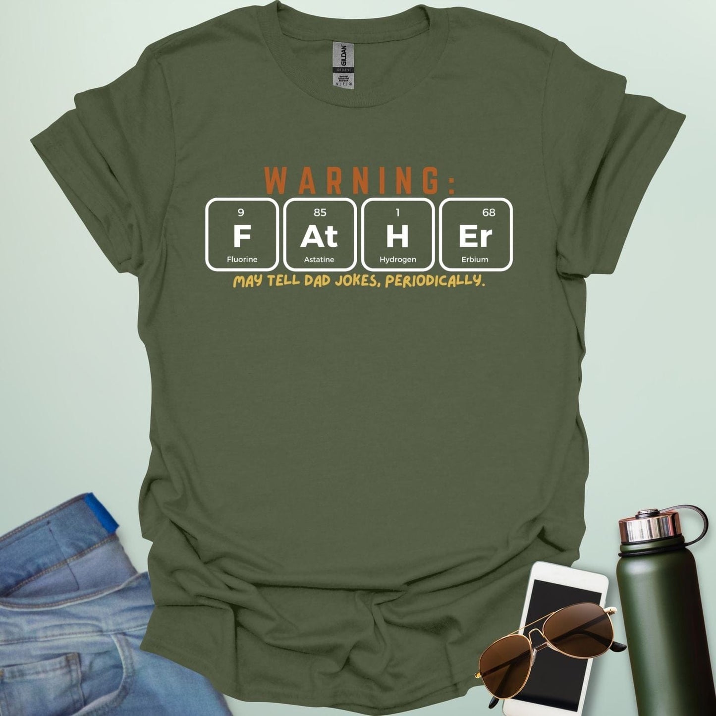 A funny periodic table t-shirt for fathers, using the elements Fluorine, Astatine, Hydrogen, and Erbium to spell 'FAtHEr'. The design says 'WARNING: FATHER MAY TELL DAD JOKES, PERIODICALLY.'