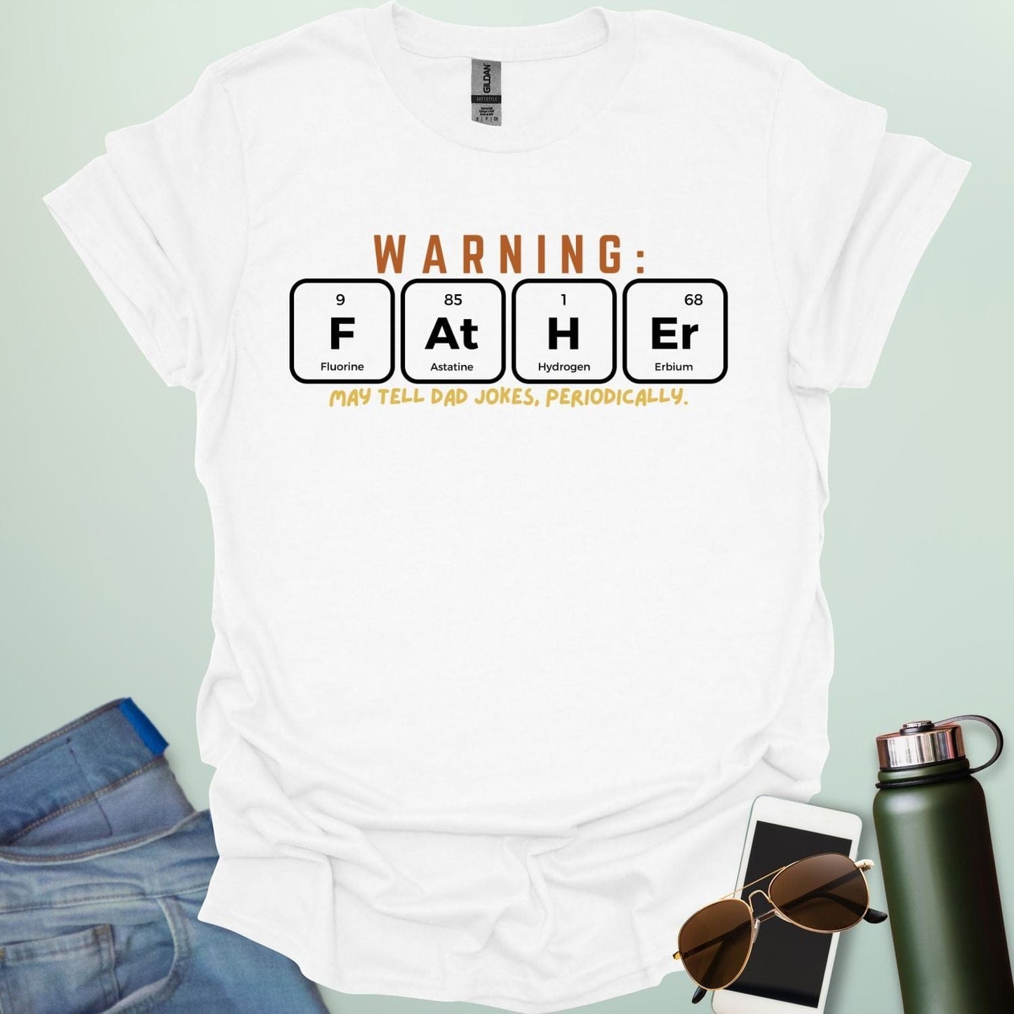 A funny periodic table t-shirt for fathers, using the elements Fluorine, Astatine, Hydrogen, and Erbium to spell 'FAtHEr'. The design says 'WARNING: FATHER MAY TELL DAD JOKES, PERIODICALLY.'