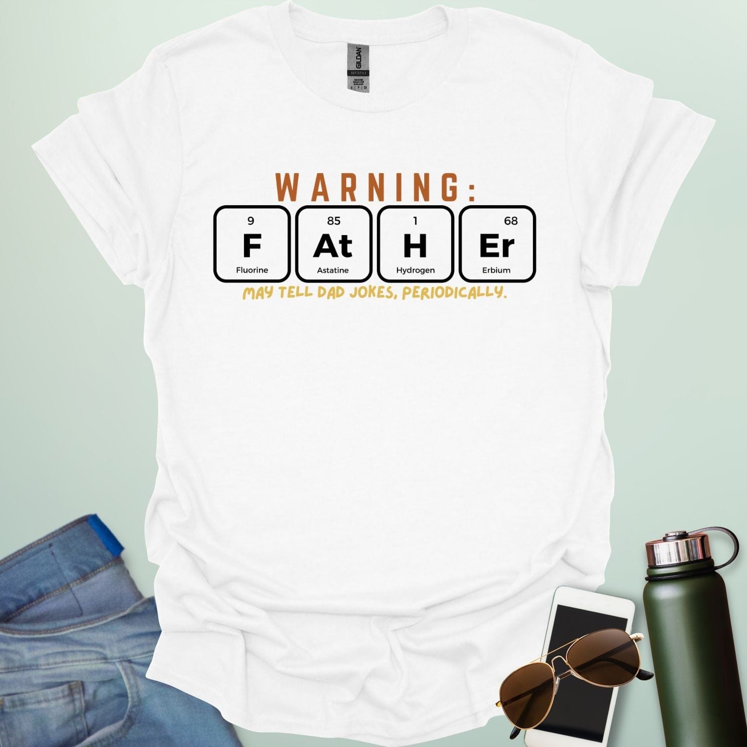 A funny periodic table t-shirt for fathers, using the elements Fluorine, Astatine, Hydrogen, and Erbium to spell 'FAtHEr'. The design says 'WARNING: FATHER MAY TELL DAD JOKES, PERIODICALLY.'