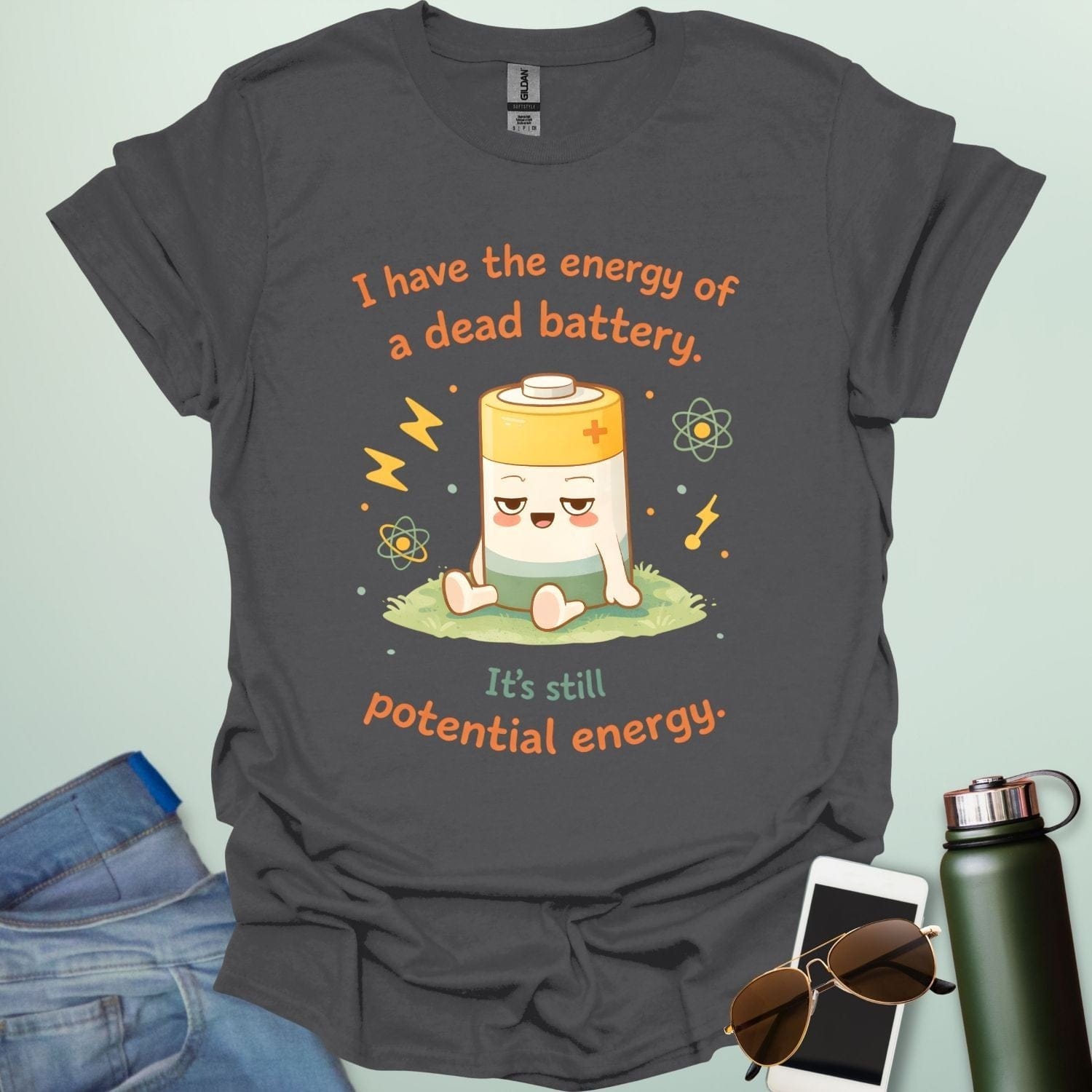 A cute cartoon graphic of a tired battery character sitting on a patch of grass with lightning bolts, atoms, and the text "I have the energy of a dead battery. It's still potential energy."