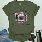 Vintage camera surrounded by flowers with the quote “When Life Gets Blurry, Adjust Your Focus.”