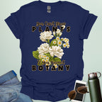 A charming t-shirt with a floral design and the text 'You Can't Grow Plants If You Haven't Botany,' a witty pun for botanists and gardeners.