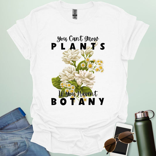 A charming t-shirt with a floral design and the text 'You Can't Grow Plants If You Haven't Botany,' a witty pun for botanists and gardeners.