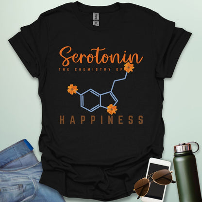 The word 'Serotonin' in cursive orange font above the text 'THE CHEMISTRY OF' in smaller orange font, above the chemical structure of serotonin in light blue with three orange flowers incorporated into the bonds. Below the chemical structure is the word 'HAPPINESS' in bold orange font.