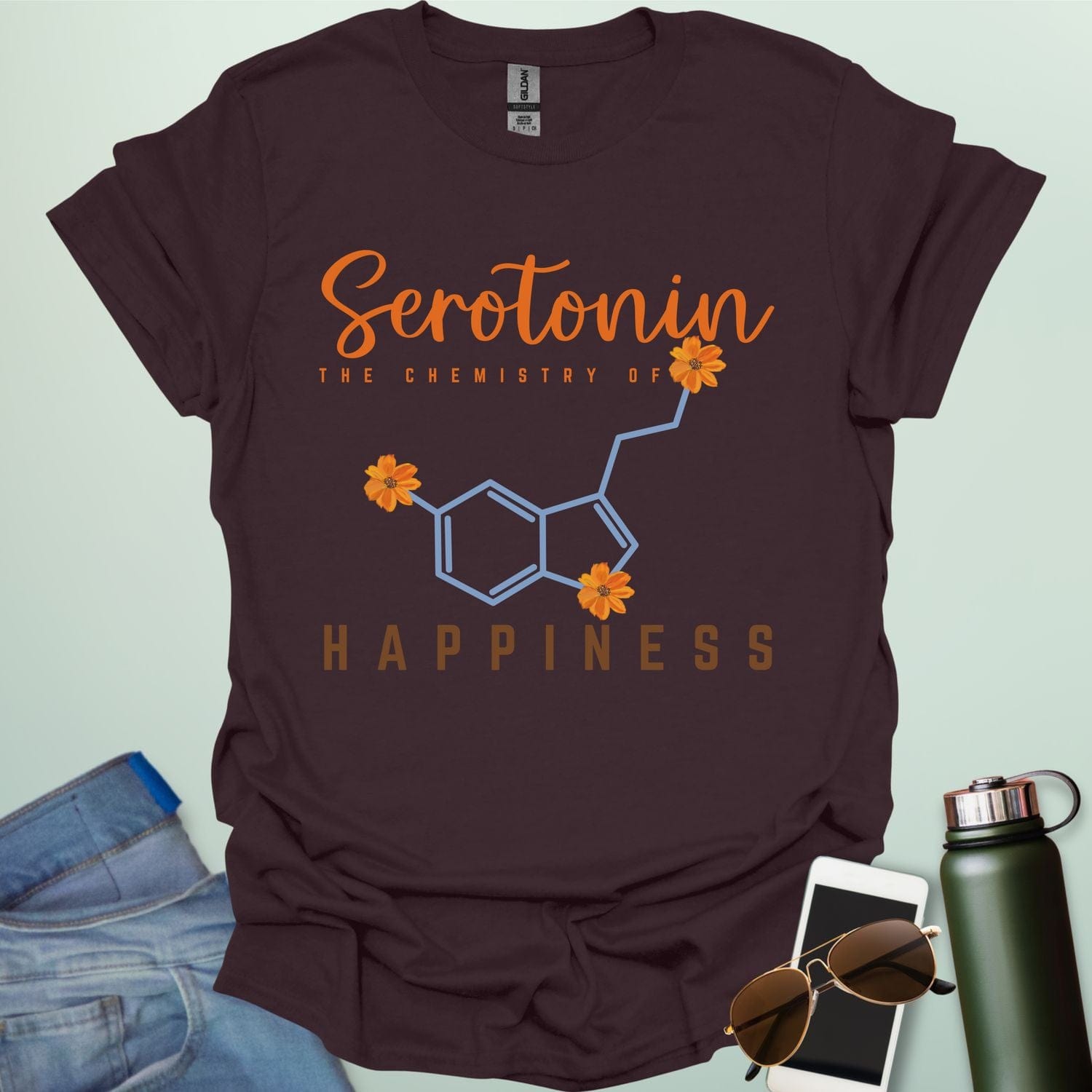 The word 'Serotonin' in cursive orange font above the text 'THE CHEMISTRY OF' in smaller orange font, above the chemical structure of serotonin in light blue with three orange flowers incorporated into the bonds. Below the chemical structure is the word 'HAPPINESS' in bold orange font.