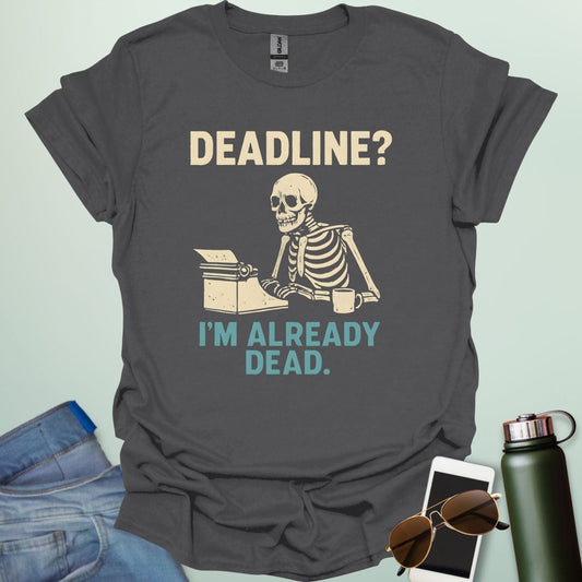 A vintage-style graphic featuring a skeleton sitting at a desk with a coffee mug, typing on a typewriter between the text "DEADLINE? I'M ALREADY DEAD."