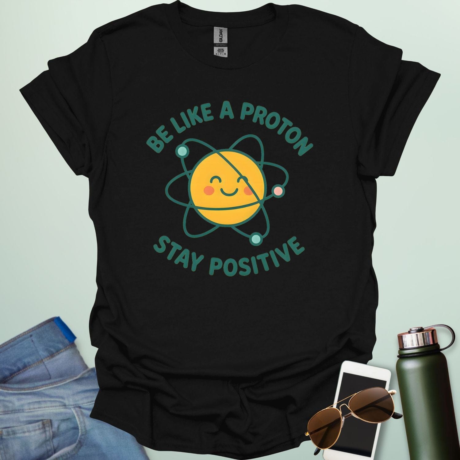 A cheerful graphic design featuring a smiling yellow proton character with orbiting electrons and the text "BE LIKE A PROTON STAY POSITIVE."