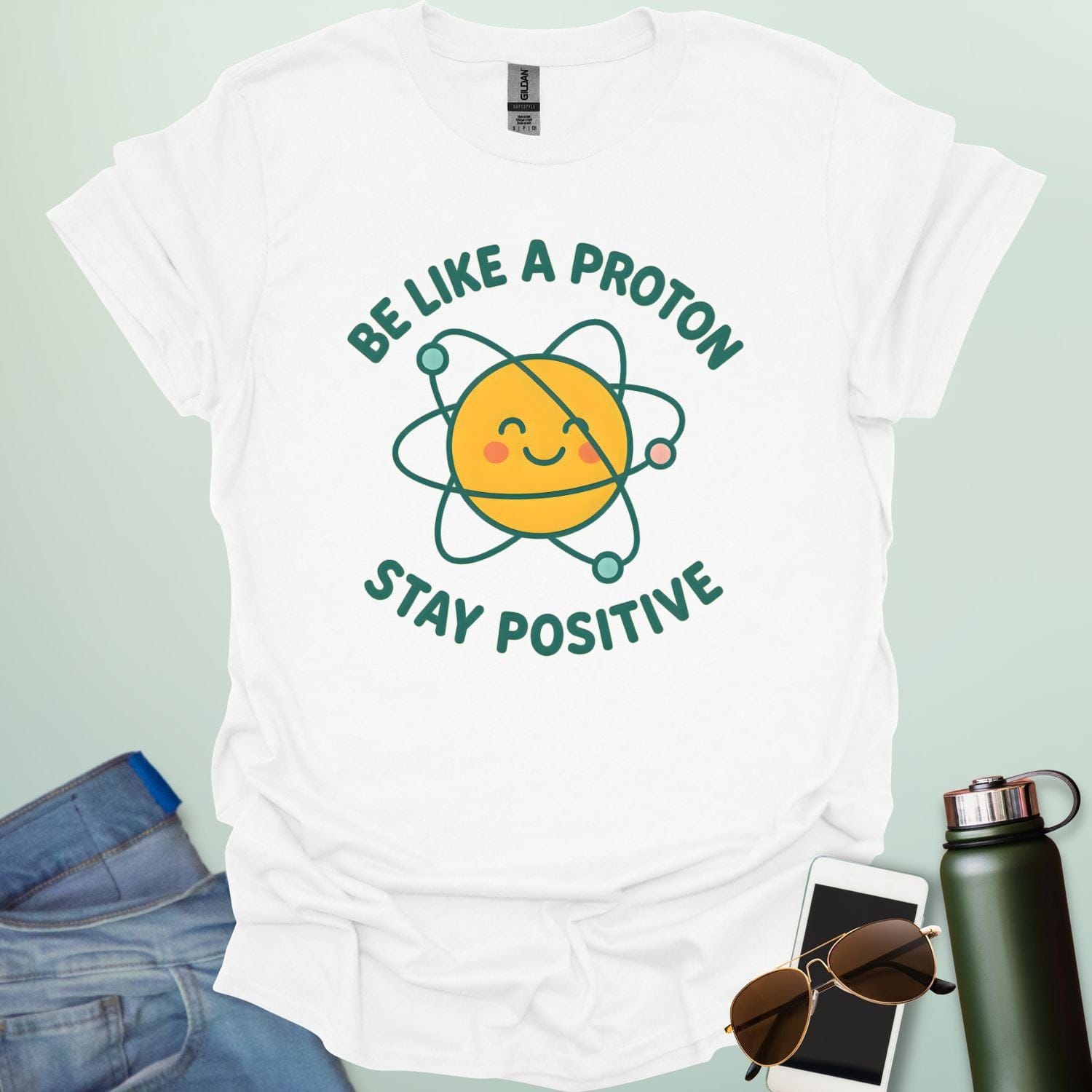 A cheerful graphic design featuring a smiling yellow proton character with orbiting electrons and the text "BE LIKE A PROTON STAY POSITIVE."