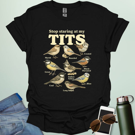 A t-shirt featuring the text "Stop staring at my TITS" above nine vintage-style illustrations of different tit bird species, including the Bearded, Crested, and Long Tailed tits.