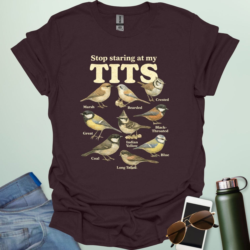A t-shirt featuring the text "Stop staring at my TITS" above nine vintage-style illustrations of different tit bird species, including the Bearded, Crested, and Long Tailed tits.