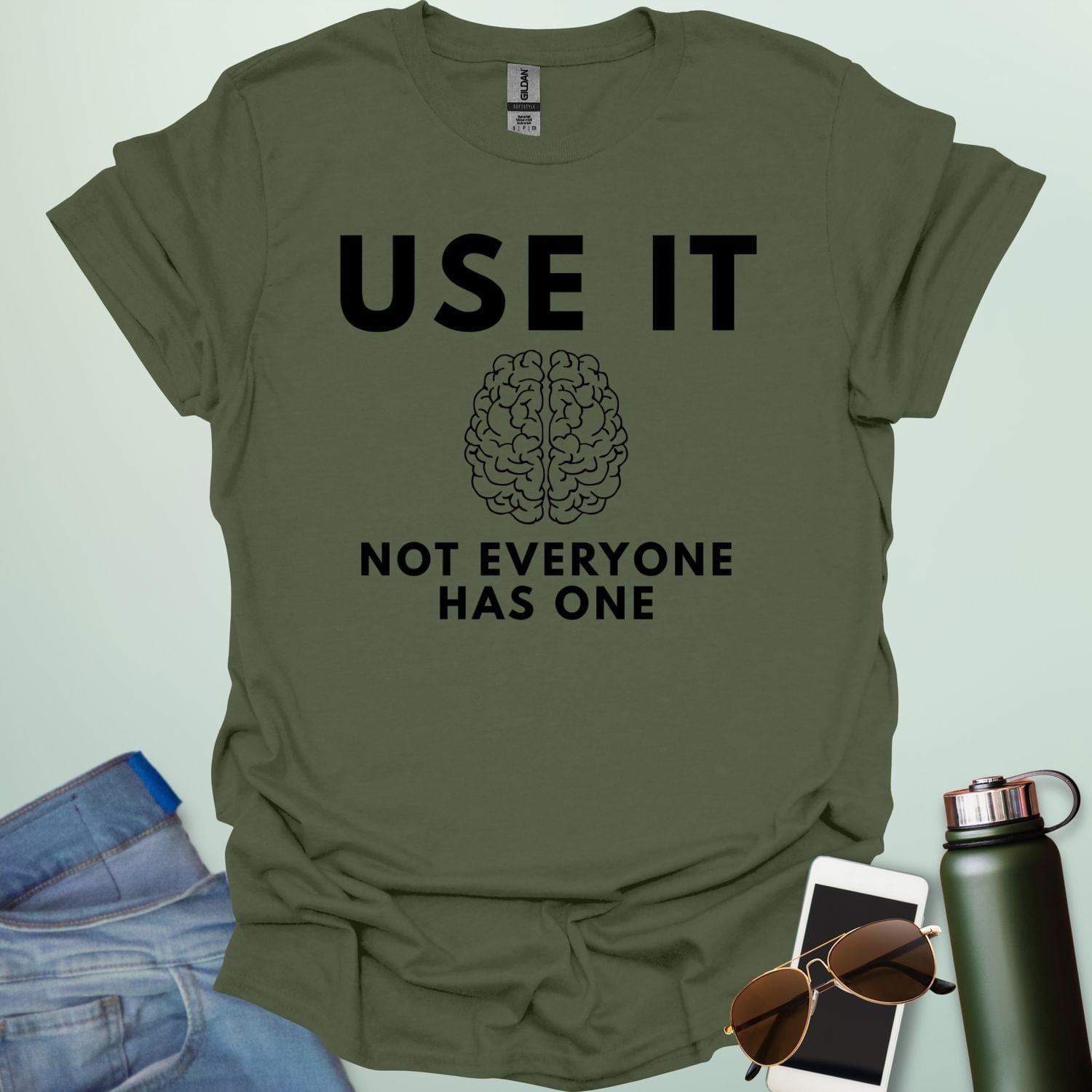 A minimalist graphic design featuring a detailed line-art illustration of a human brain centered between the bold text "USE IT" and "NOT EVERYONE HAS ONE."