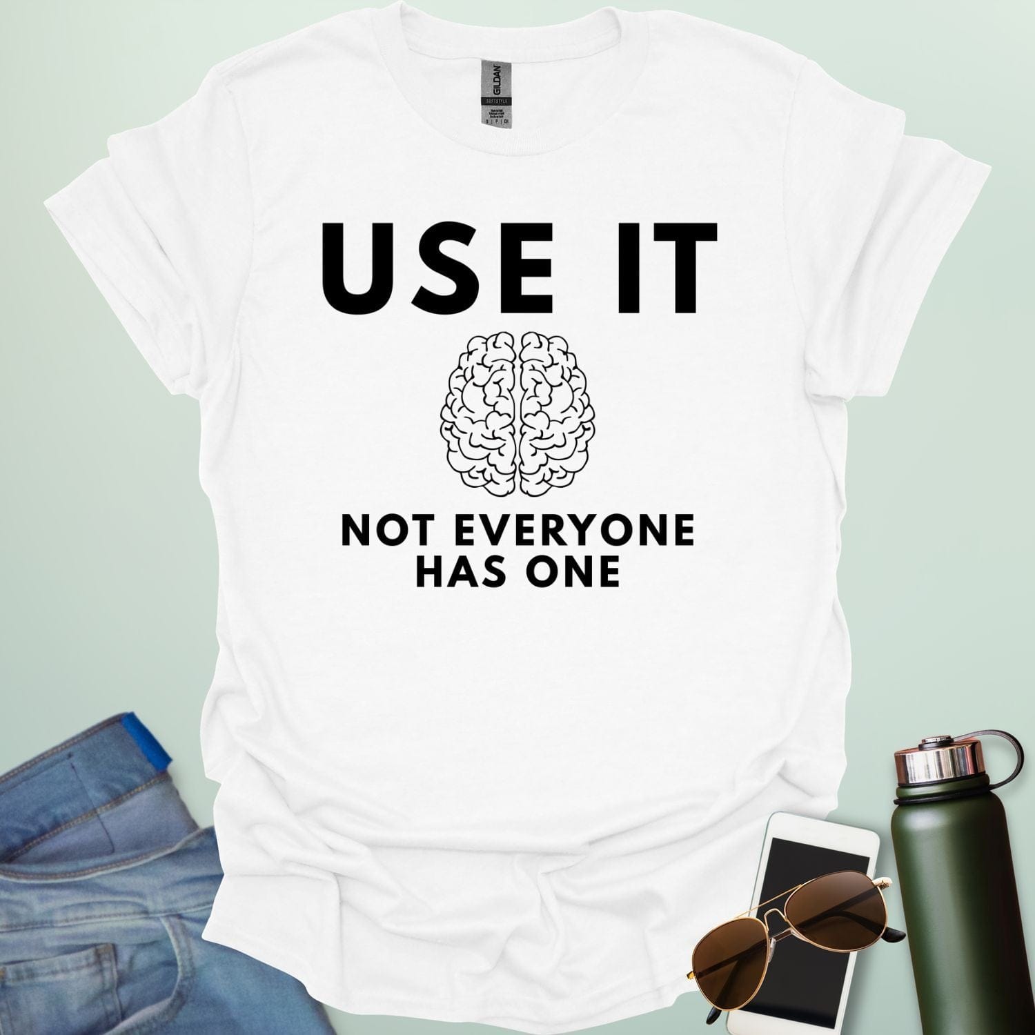 A minimalist graphic design featuring a detailed line-art illustration of a human brain centered between the bold text "USE IT" and "NOT EVERYONE HAS ONE."