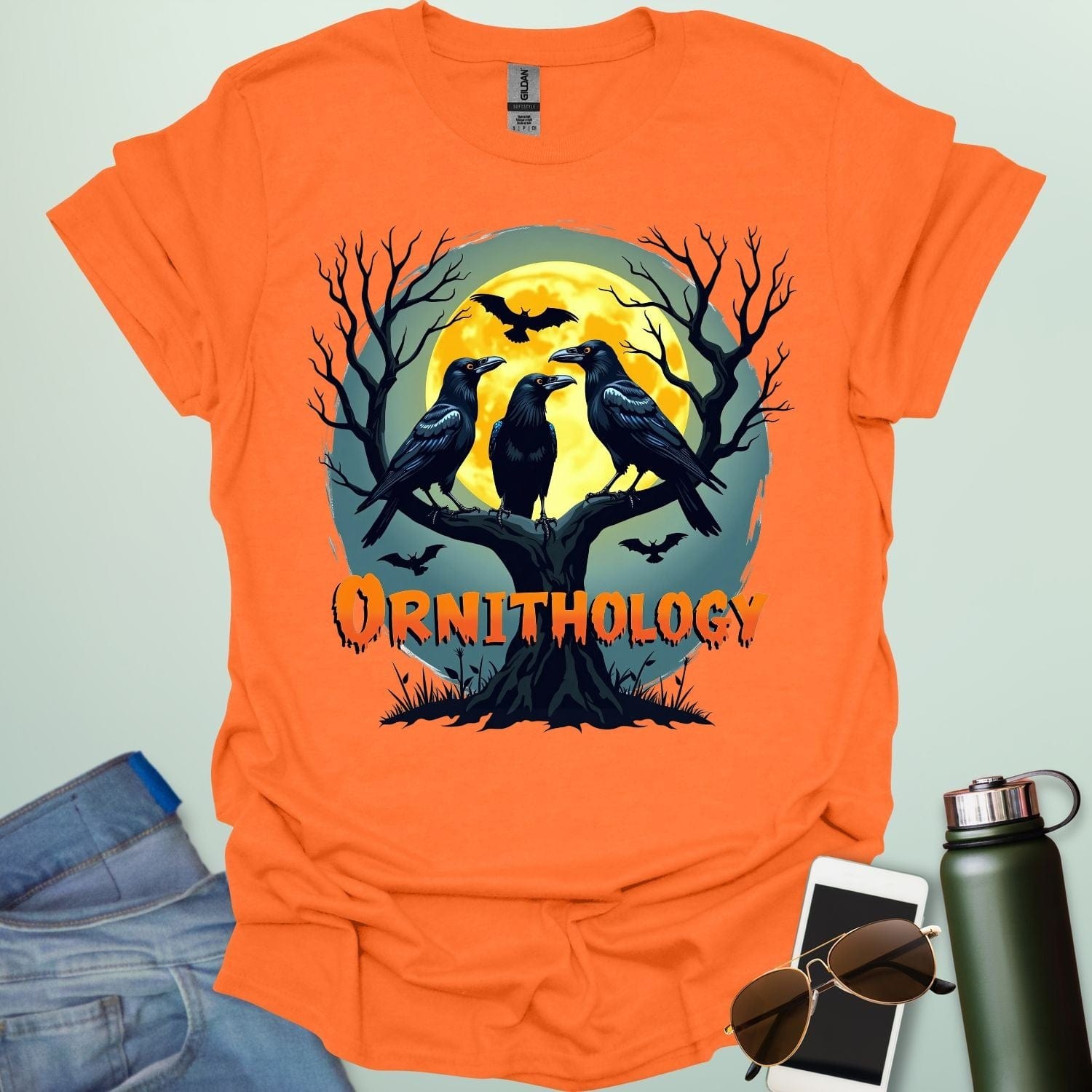 Ornithology Raven Halloween t-shirt featuring a raven perched with spooky Halloween elements — science & bird lover design.