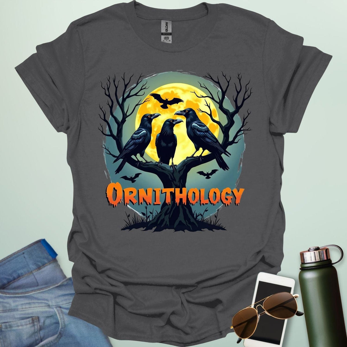 Ornithology Raven Halloween t-shirt featuring a raven perched with spooky Halloween elements — science & bird lover design.