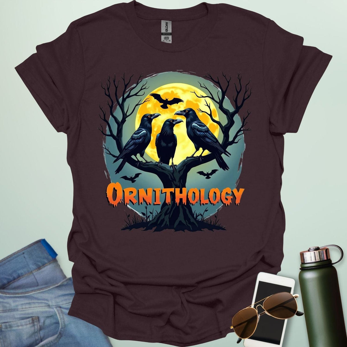 Ornithology Raven Halloween t-shirt featuring a raven perched with spooky Halloween elements — science & bird lover design.
