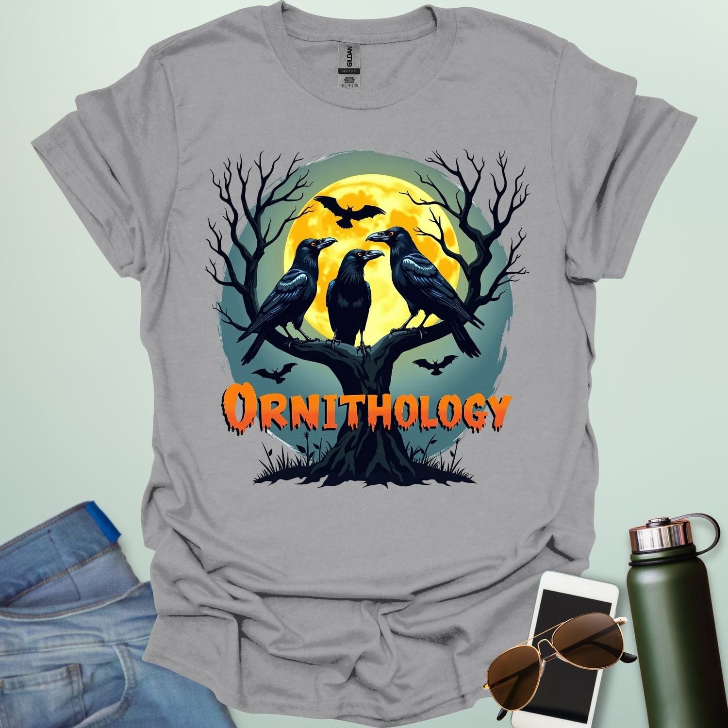 Ornithology Raven Halloween t-shirt featuring a raven perched with spooky Halloween elements — science & bird lover design.