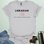 A graphic design featuring the word "LIBRARIAN" in bold sans-serif text above an illustration of an open file box with folders and the phrase "the original search engine" below.