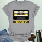 Retro cassette mix-tape graphic on tech-nostalgia tee with geometric patterns and 80s/90s style.