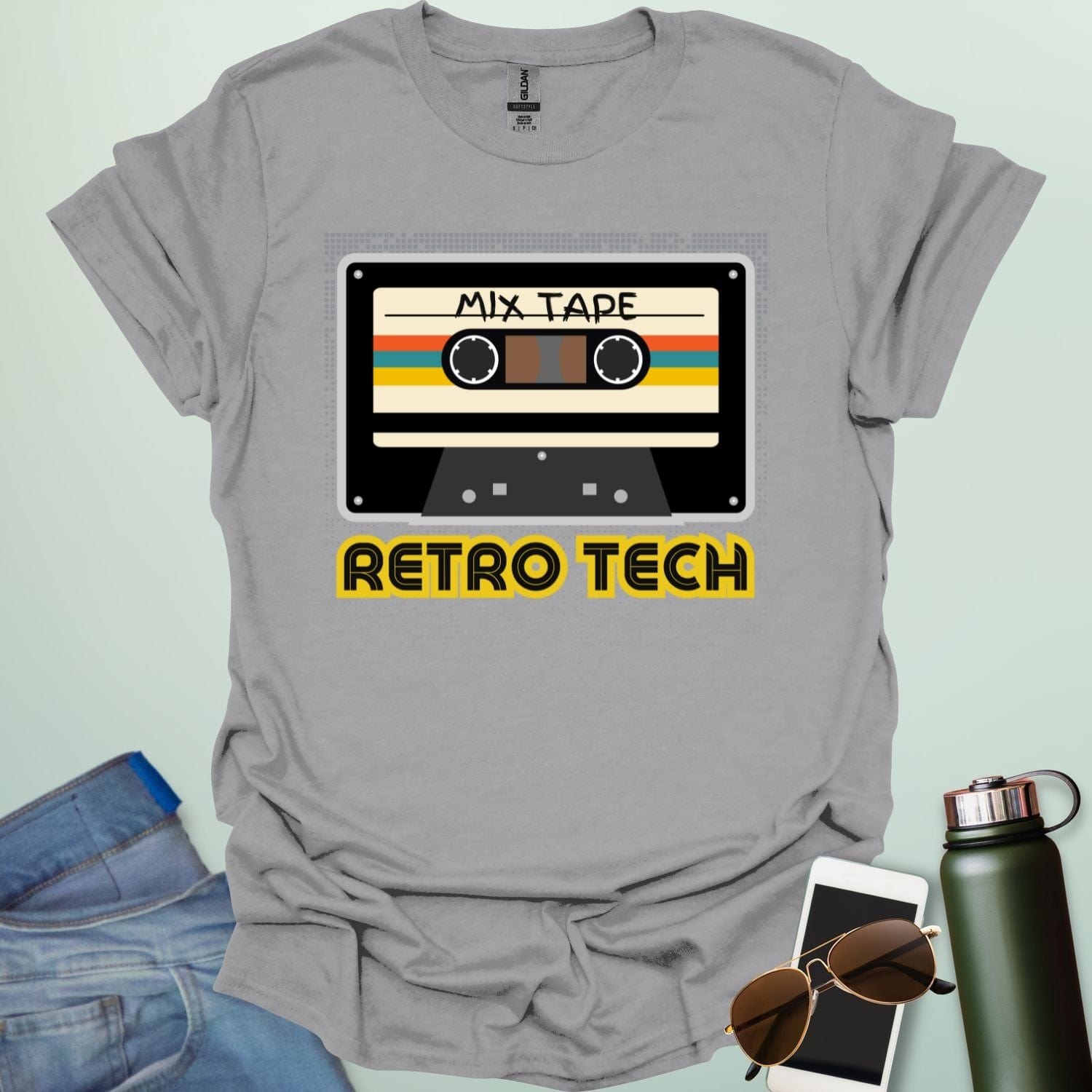 Retro cassette mix-tape graphic on tech-nostalgia tee with geometric patterns and 80s/90s style.