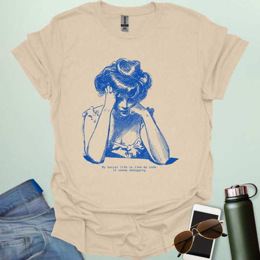 A tan shirt with blue line art illustration of a woman looking frustrated with her head in her hands, above the text 'My social life is like my code:' and 'It needs debugging.