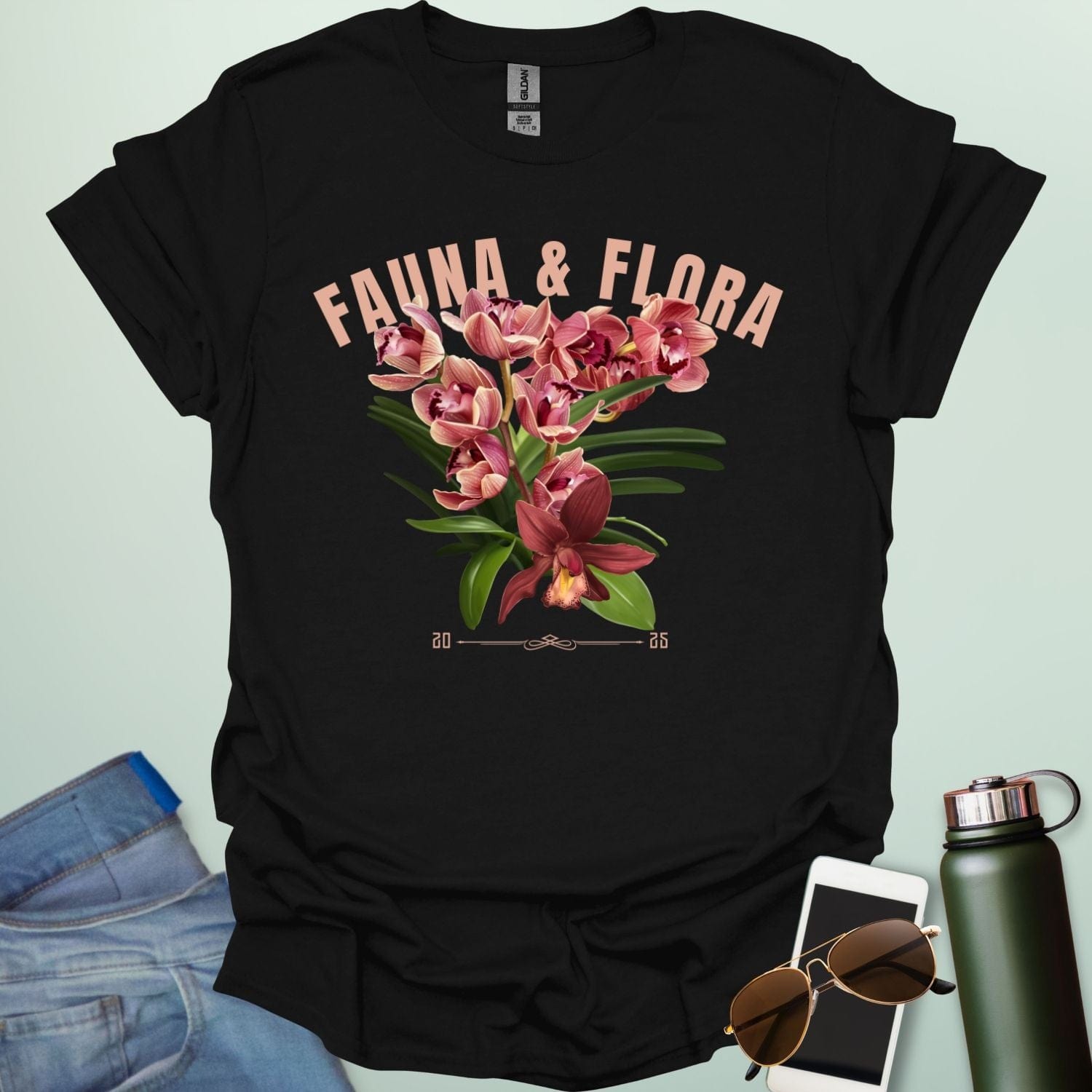 A beautiful t-shirt with a detailed illustration of a pink orchid and green leaves, perfect for gardeners and nature lovers.