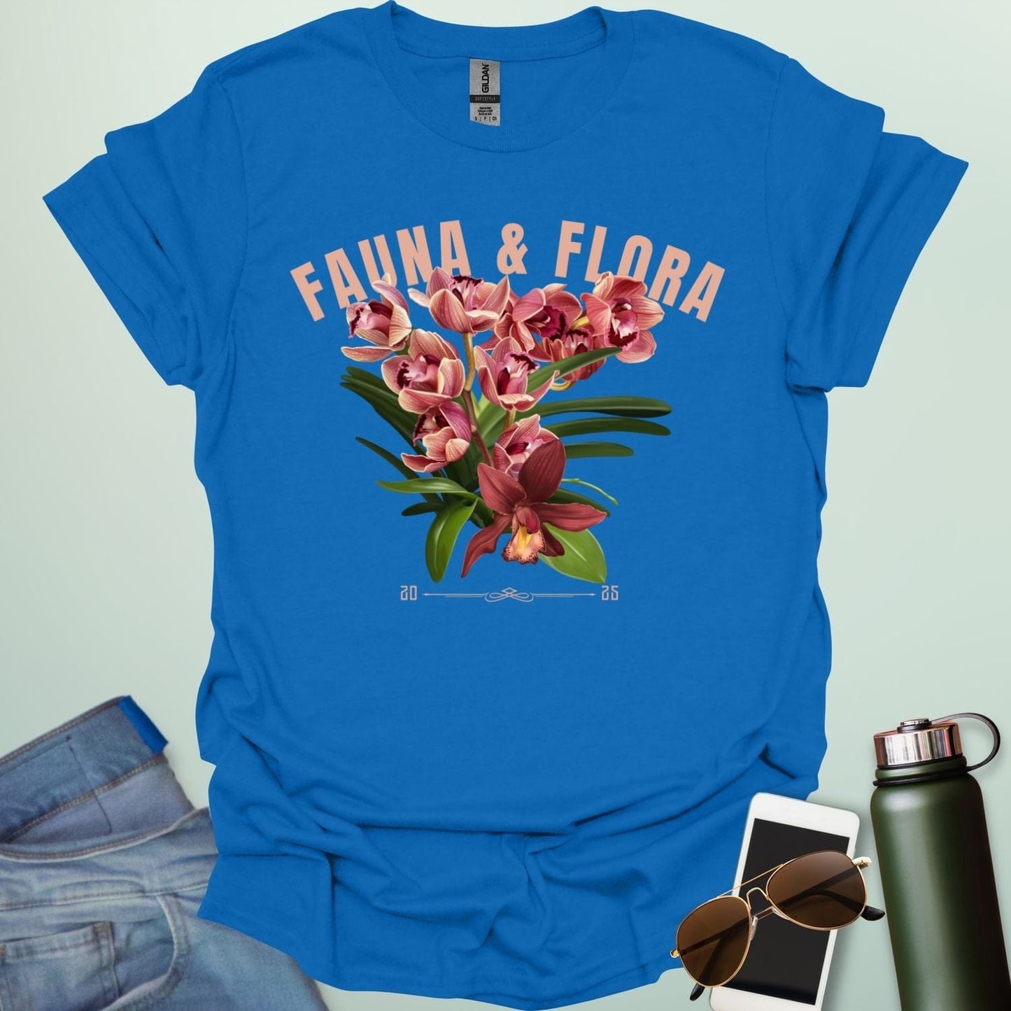 A beautiful t-shirt with a detailed illustration of a pink orchid and green leaves, perfect for gardeners and nature lovers.