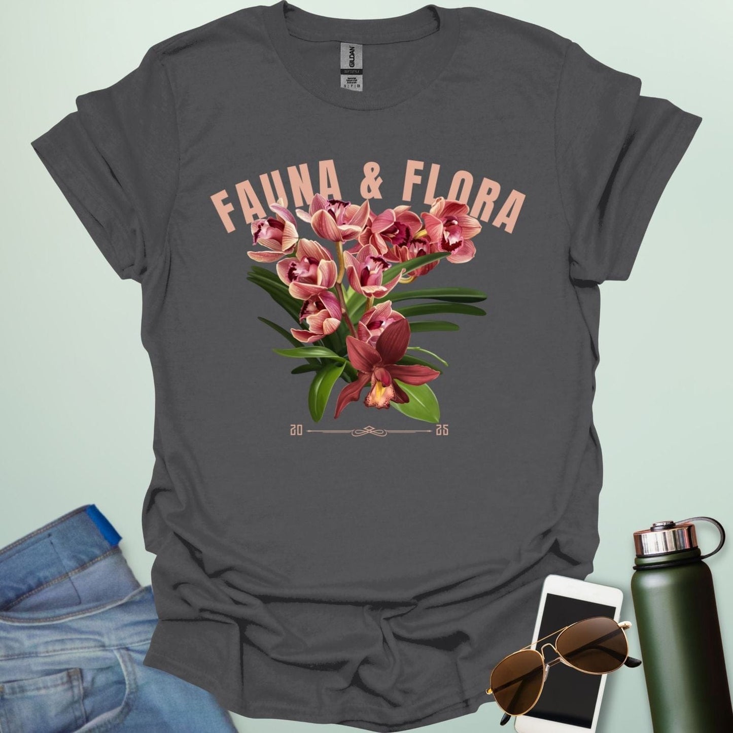 A beautiful t-shirt with a detailed illustration of a pink orchid and green leaves, perfect for gardeners and nature lovers.