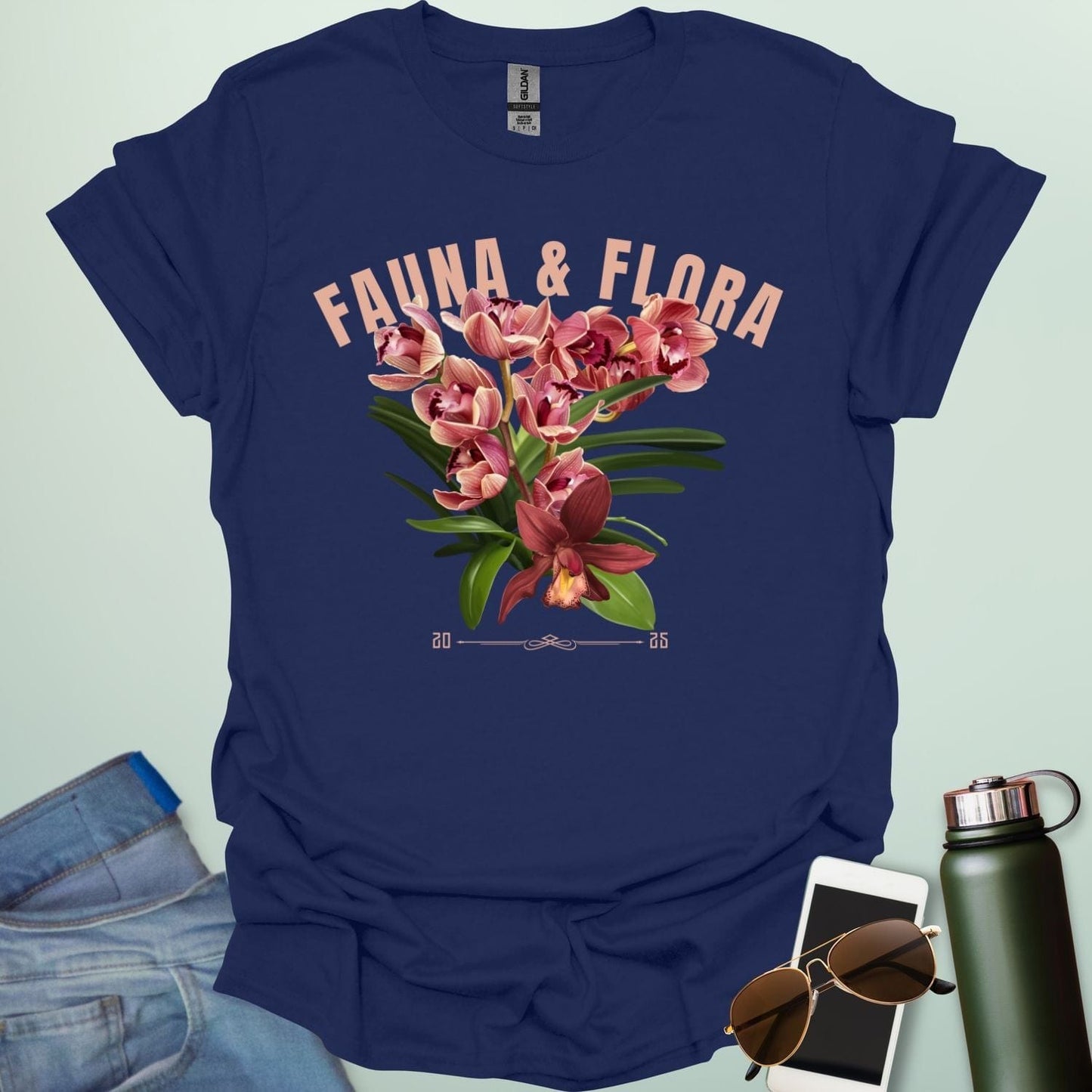 A beautiful t-shirt with a detailed illustration of a pink orchid and green leaves, perfect for gardeners and nature lovers.