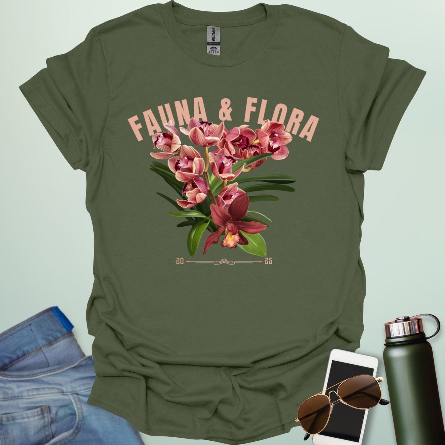 A beautiful t-shirt with a detailed illustration of a pink orchid and green leaves, perfect for gardeners and nature lovers.