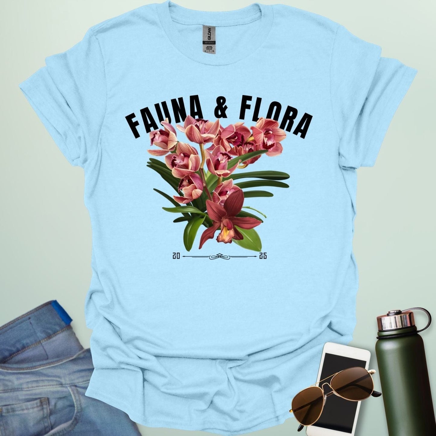 A beautiful t-shirt with a detailed illustration of a pink orchid and green leaves, perfect for gardeners and nature lovers.