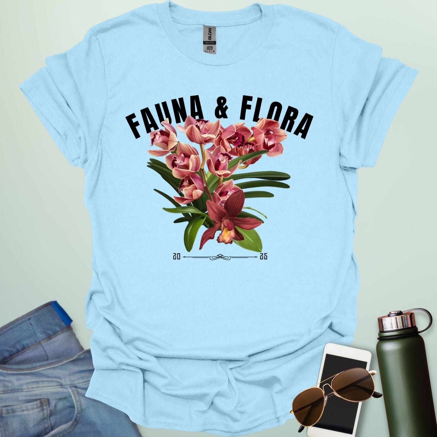 A beautiful t-shirt with a detailed illustration of a pink orchid and green leaves, perfect for gardeners and nature lovers.