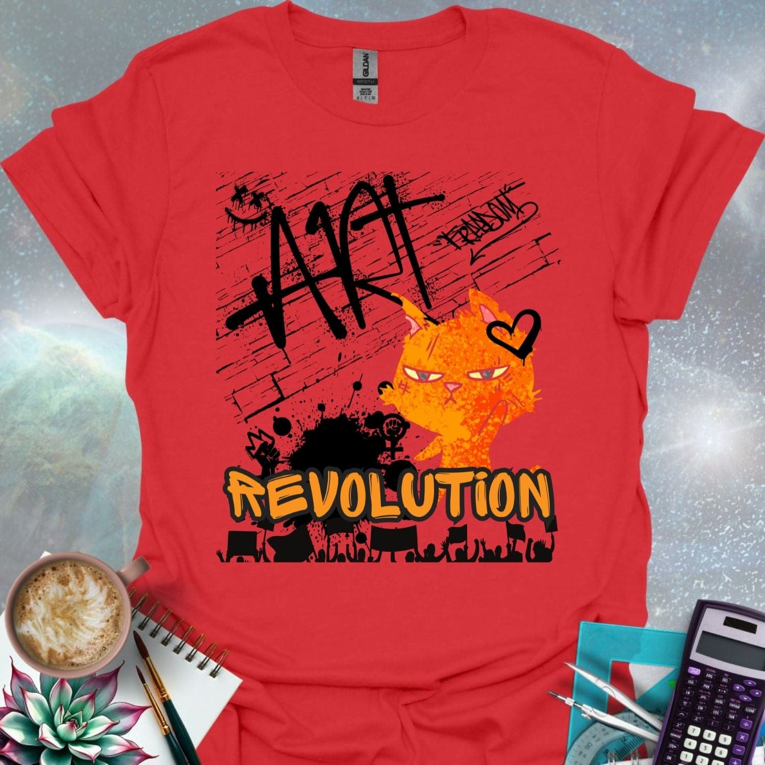 The word 'ART' in a bold, black graffiti style above an orange cartoon cat with a determined expression and a heart graphic. Below is the word 'REVOLUTION' in orange outlined in black, above a silhouette of a crowd holding signs.
