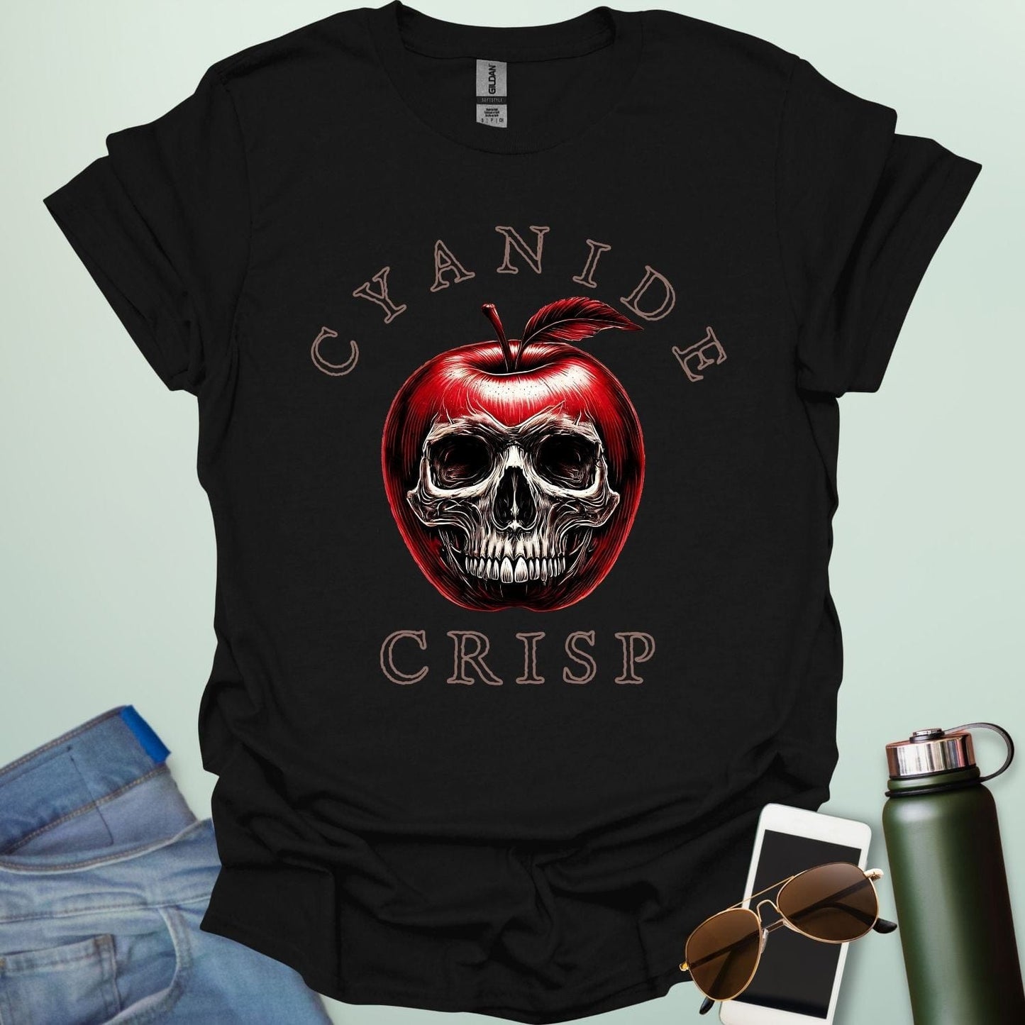 Cyanide Apple Crisp t-shirt featuring apple slice graphic with chemistry symbol/spoiler elements — a dark humor Halloween design for science lovers.