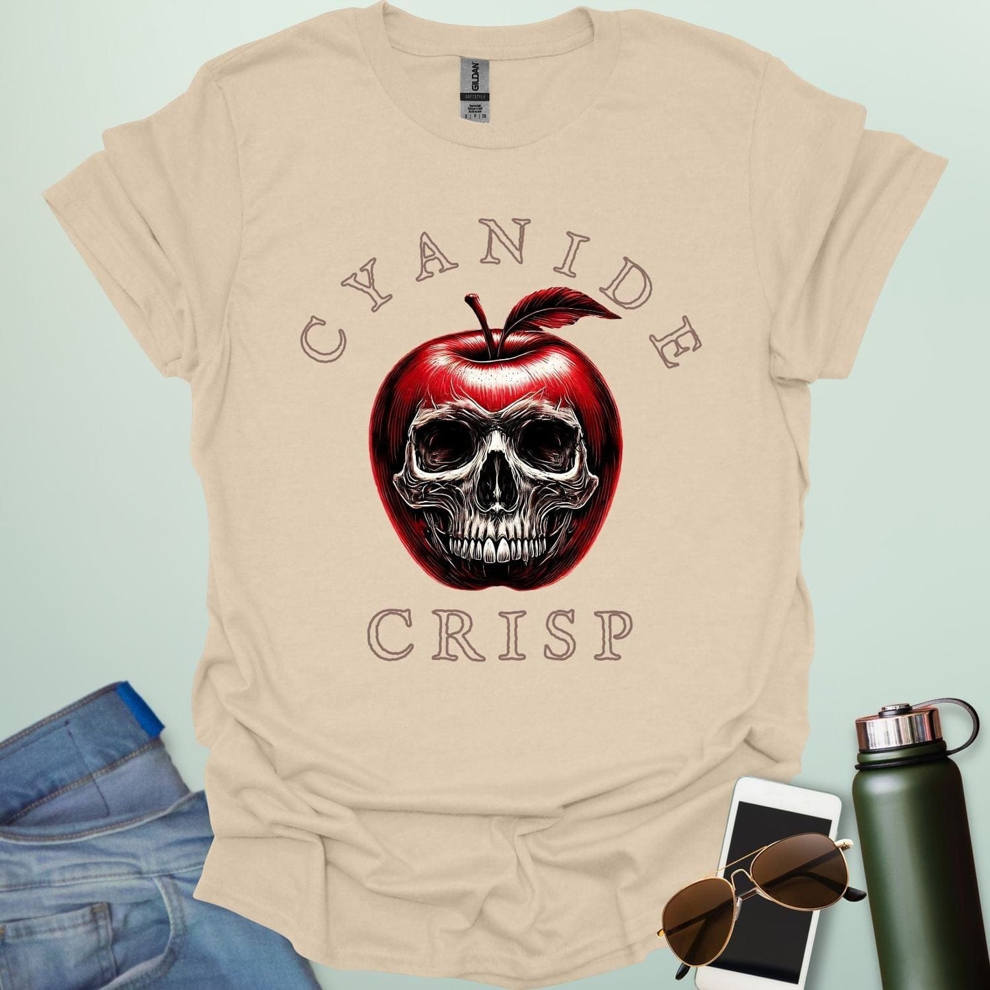 Cyanide Apple Crisp t-shirt featuring apple slice graphic with chemistry symbol/spoiler elements — a dark humor Halloween design for science lovers.