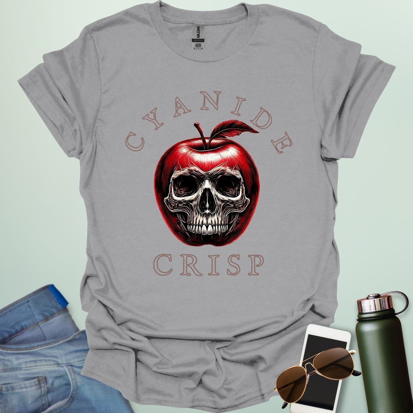 Cyanide Apple Crisp t-shirt featuring apple slice graphic with chemistry symbol/spoiler elements — a dark humor Halloween design for science lovers.