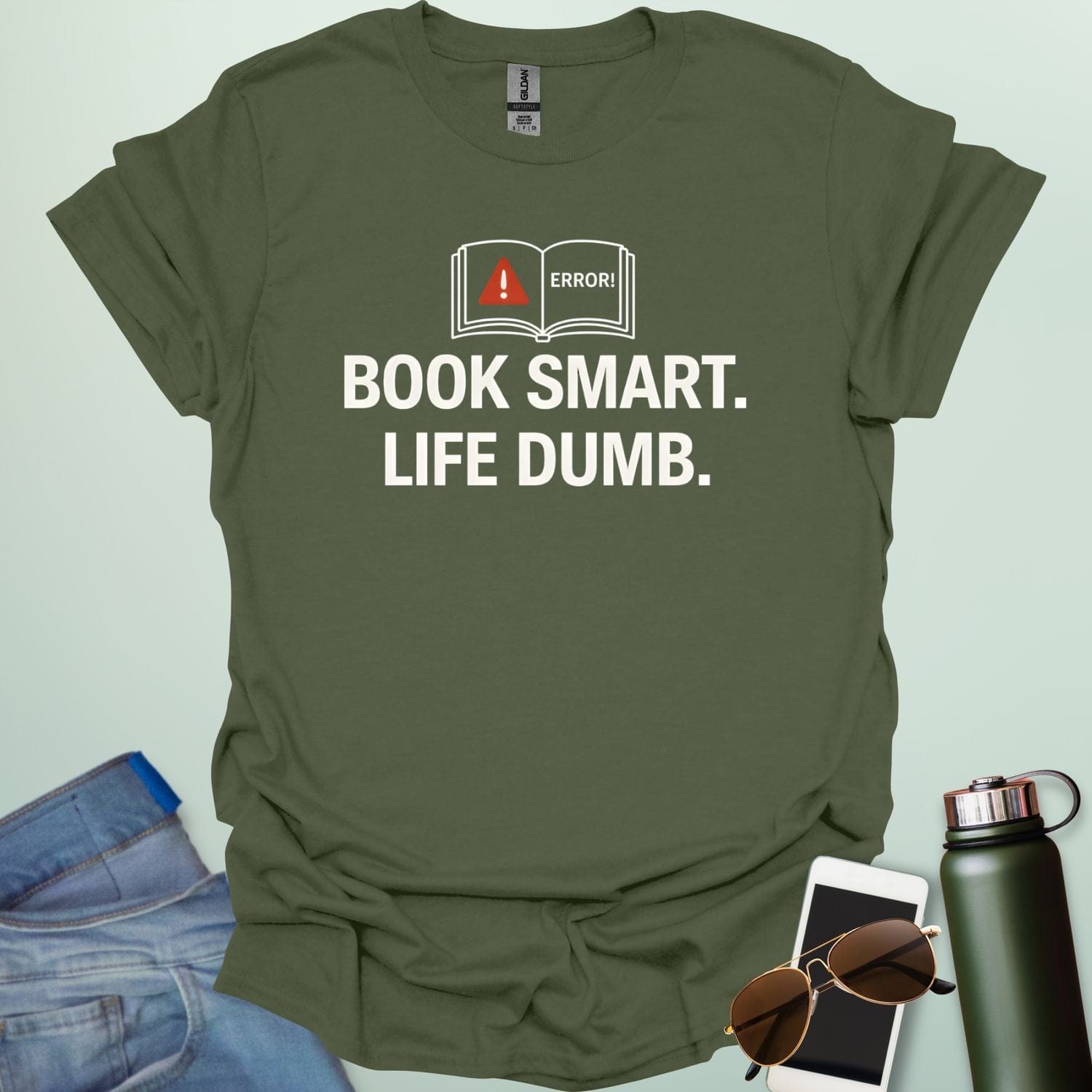 A minimalist graphic design featuring an open book with a red warning triangle and the word "ERROR!" above the bold text "BOOK SMART. LIFE DUMB."
