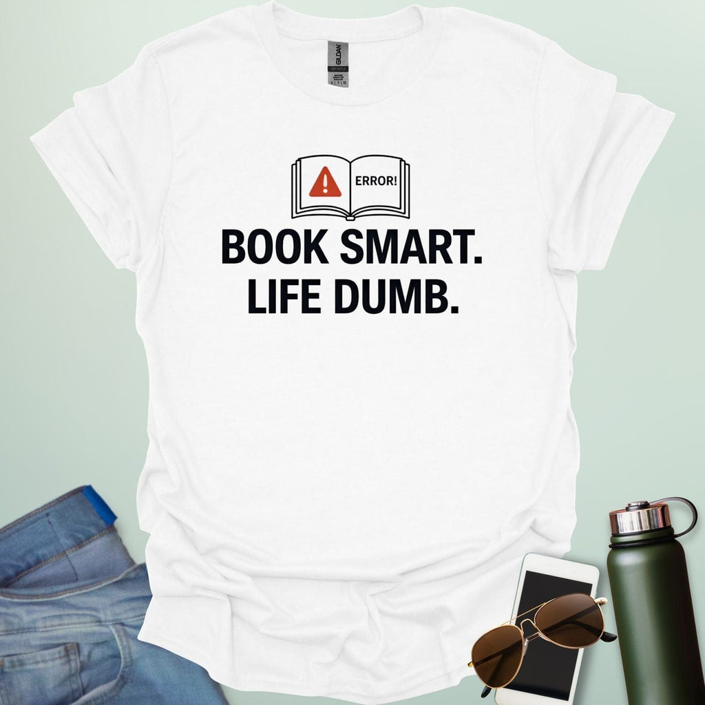 A minimalist graphic design featuring an open book with a red warning triangle and the word "ERROR!" above the bold text "BOOK SMART. LIFE DUMB."